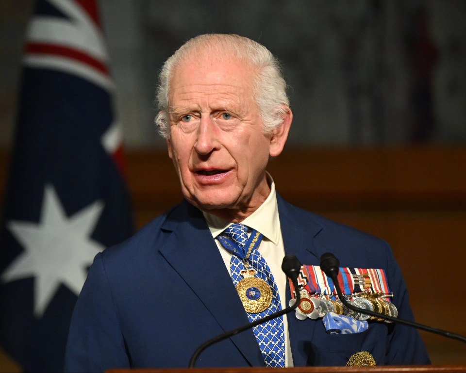 a man in a blue suit and tie is giving a speech
