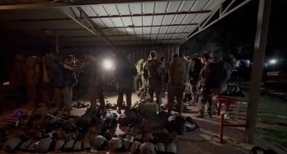 a group of soldiers are gathered under a roof with the number 98 on the bottom