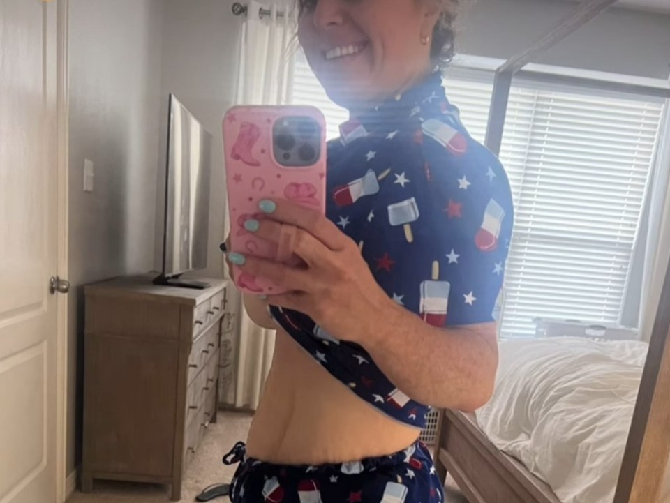 a woman taking a picture of herself in a mirror