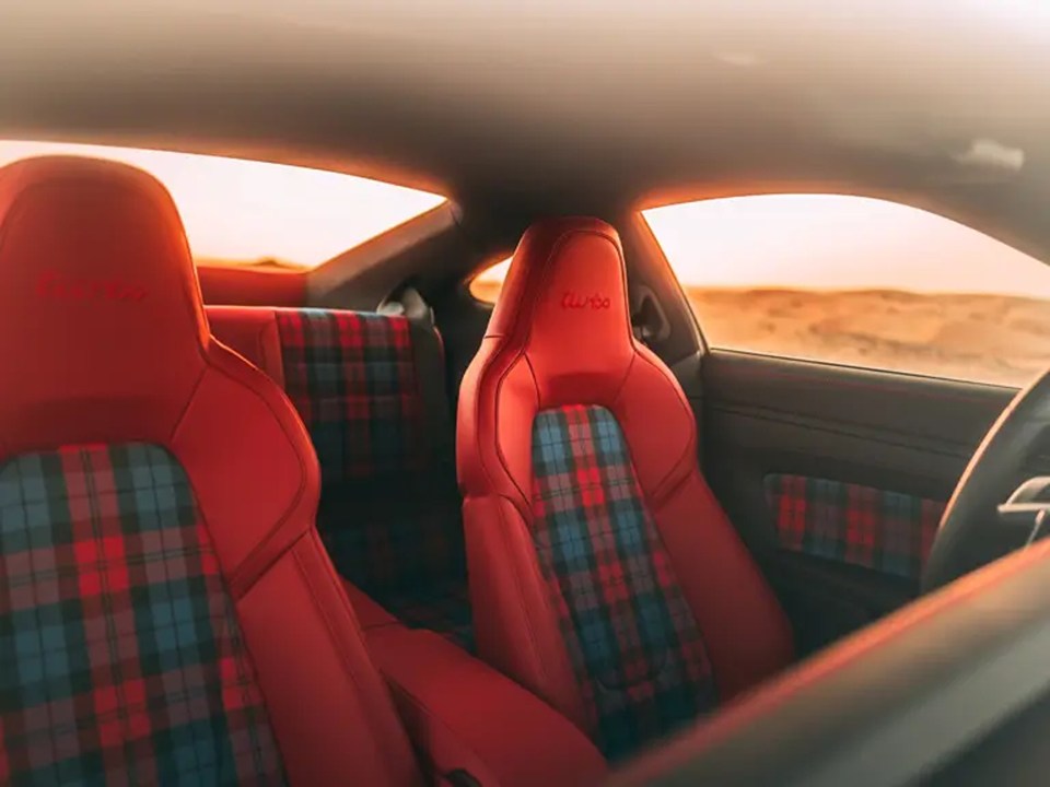 red plaid seats in a porsche turbo car