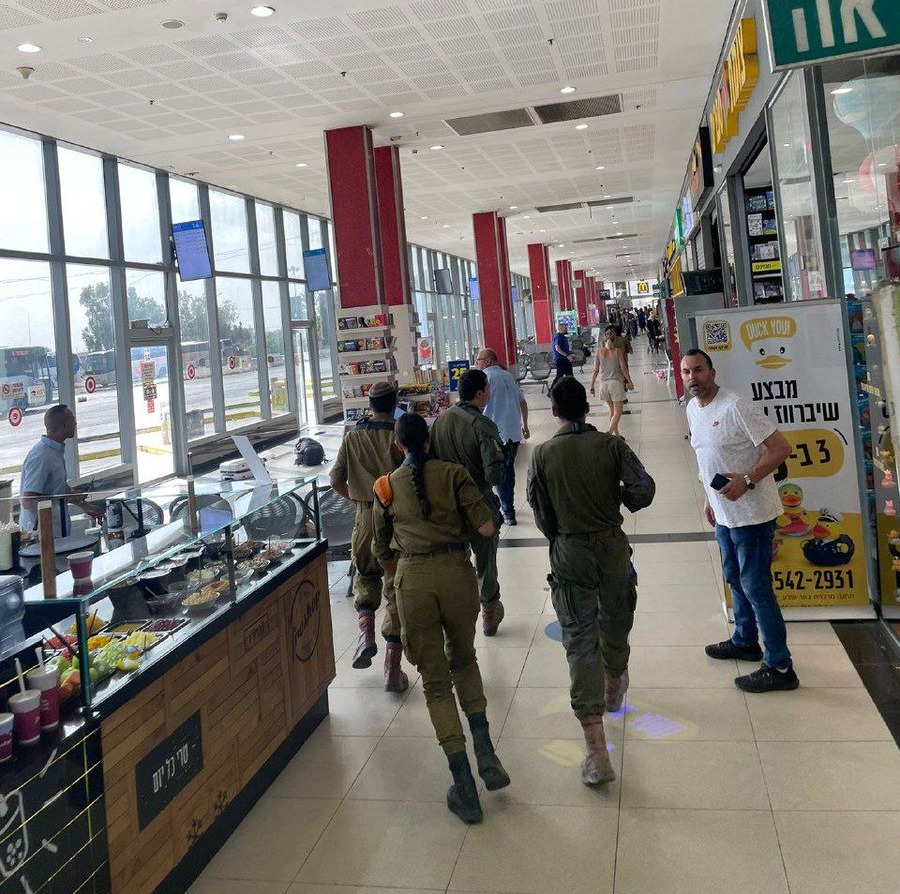 a group of soldiers are walking through a shopping mall