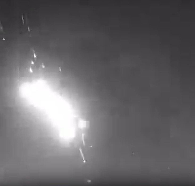 a black and white photo of a fireworks display in the night sky .