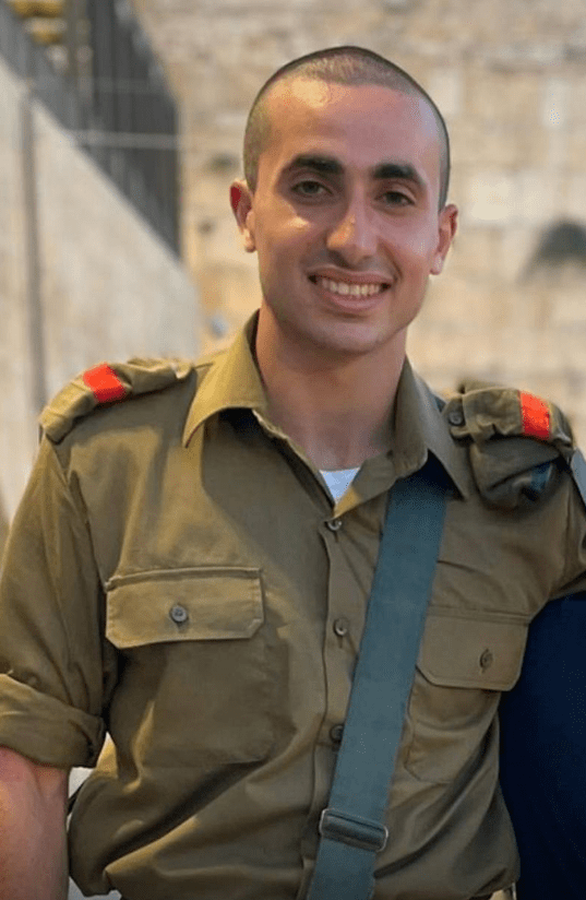 a man in a military uniform is smiling for the camera
