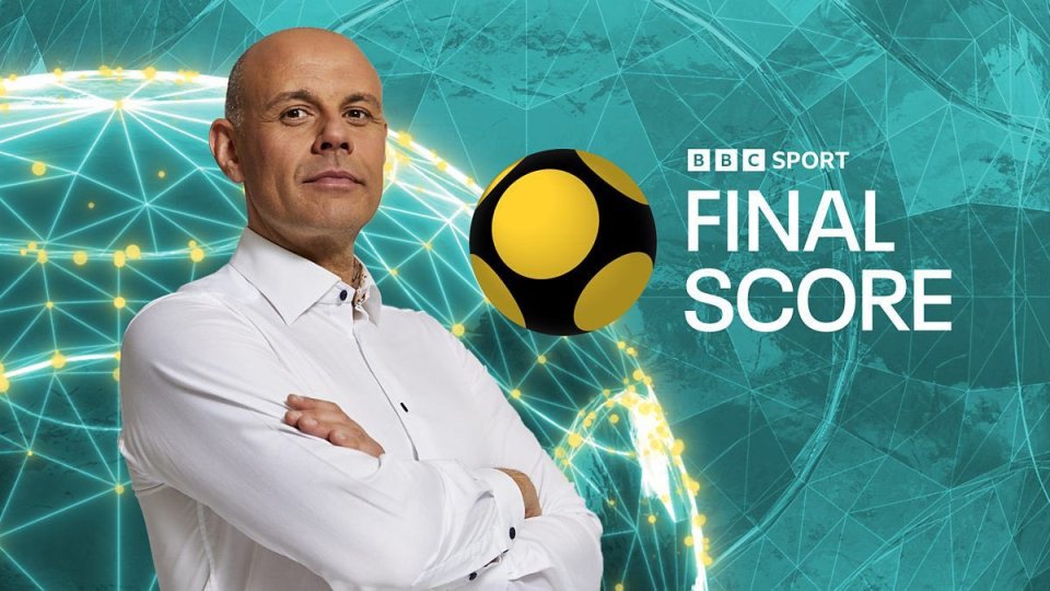 a man stands in front of a bbc sport final score logo
