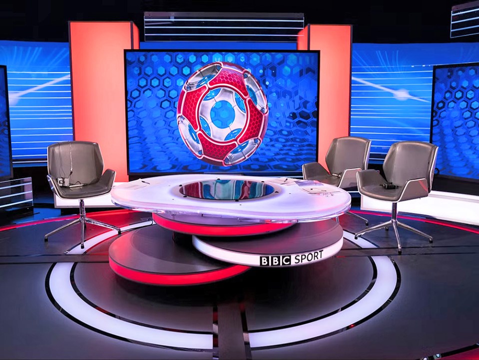 a bbc sport studio with a round table and chairs