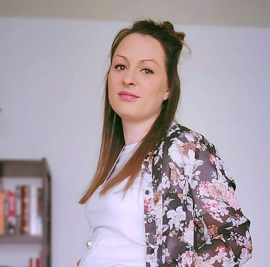 a woman wearing a white shirt and a floral jacket