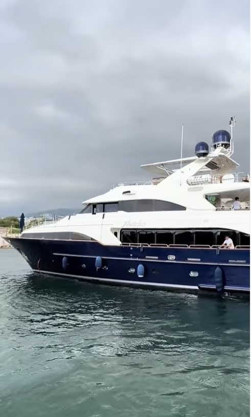 a large white and blue yacht is floating in the water