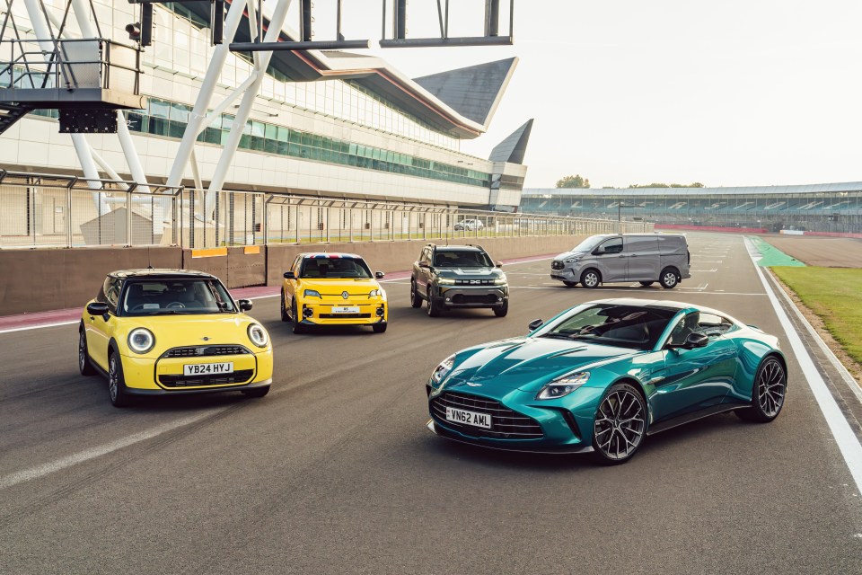 four cars are driving on a race track and one has a license plate that says t824 awj