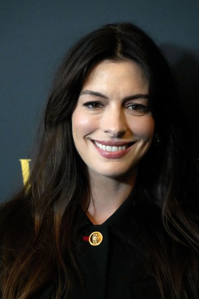 a close up of a woman 's face with a button that says ' i love you ' on it