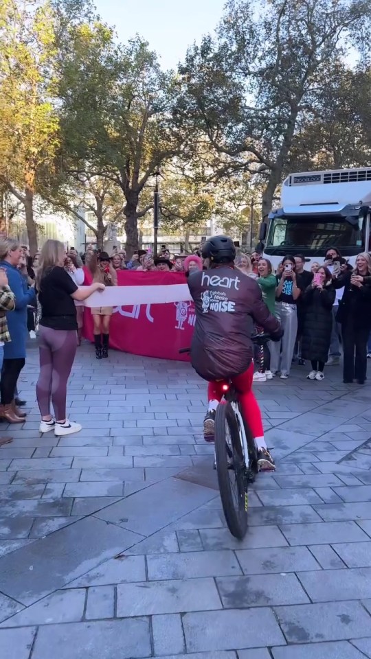 a man riding a bike with the word heart on his shirt