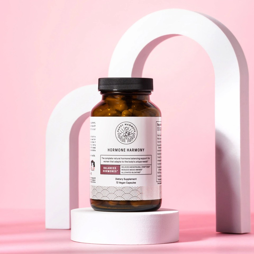 a bottle of hormone harmony is sitting on a white podium