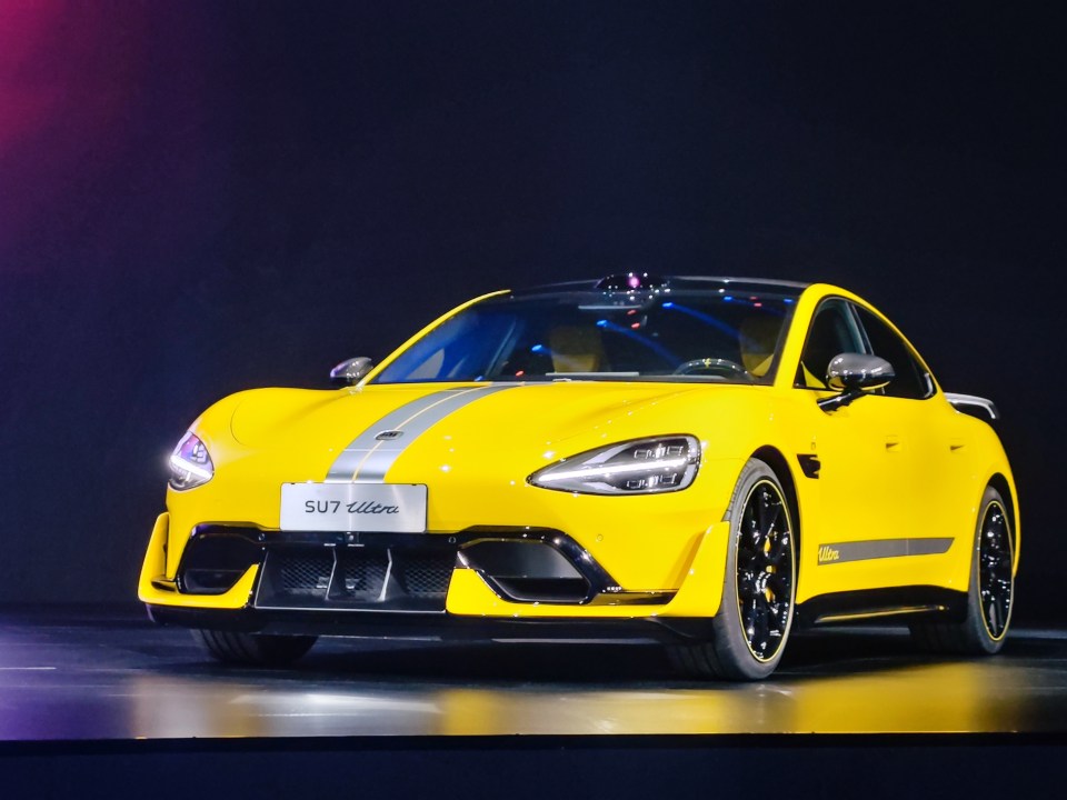 a yellow car with the word sut on the front