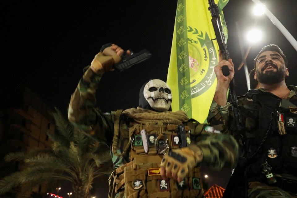 Iran-backed shi'ite groups fighters celebrate on a street, after the IRGC attack on Israel, in Basra, Iraq, October 1, 2024. REUTERS/Mohammed Aty