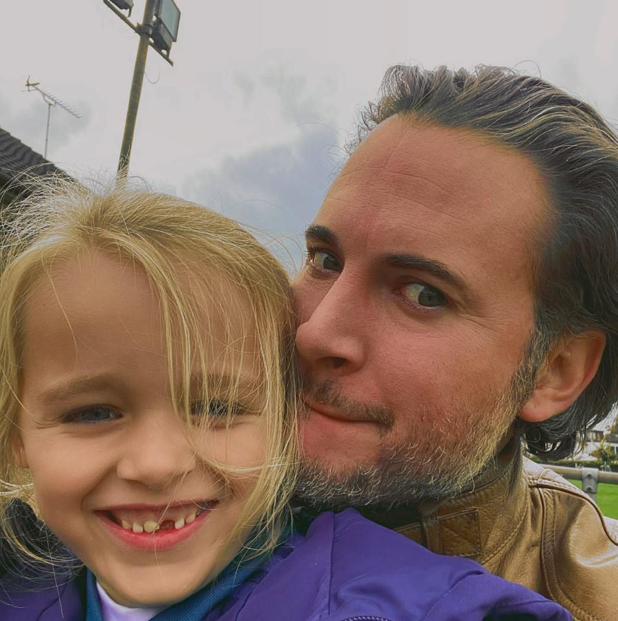 a man and a little girl are posing for a picture