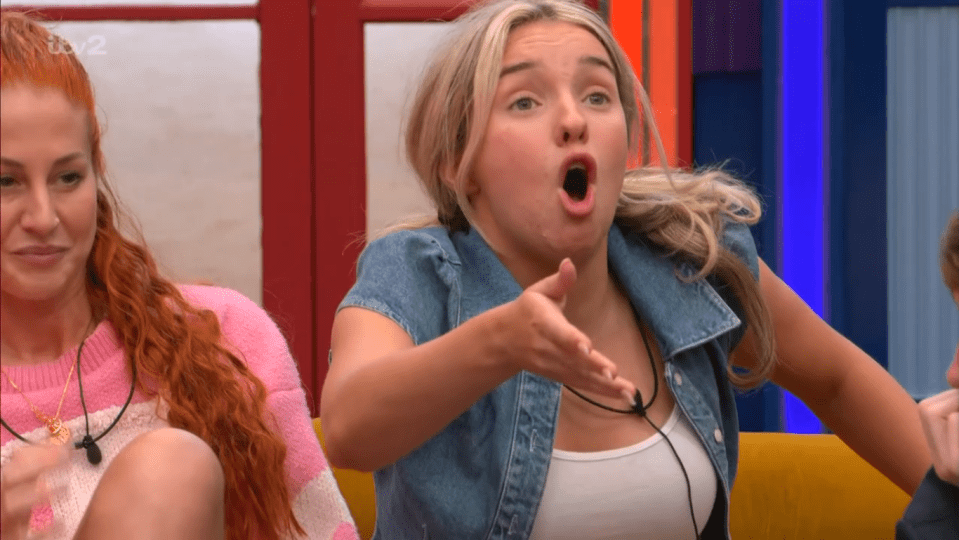 a woman in a denim vest is making a funny face