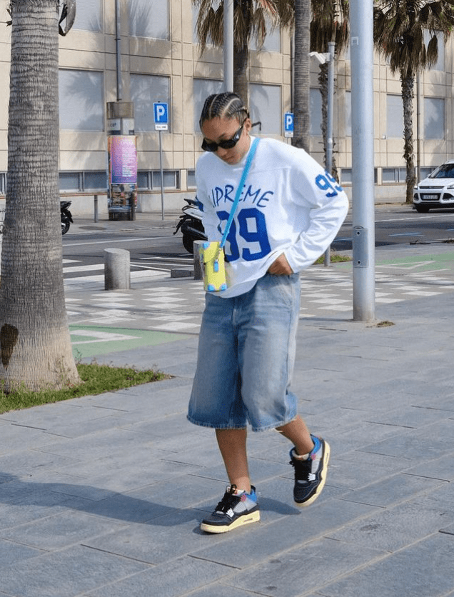a person wearing a white sweatshirt with the number 39 on it