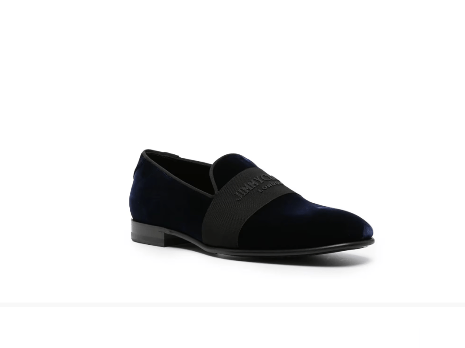 a pair of black jimmy choo shoes on a white background