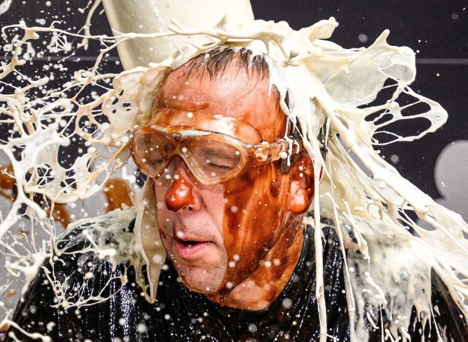 a photo of a man covered in milk with a caption that says editorial use only