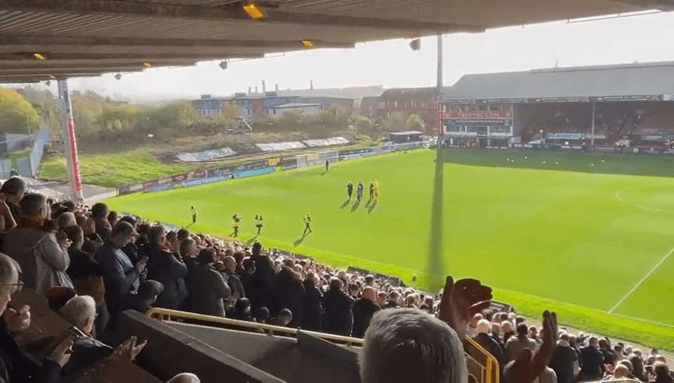 a crowd of people watching a soccer game in a stadium
