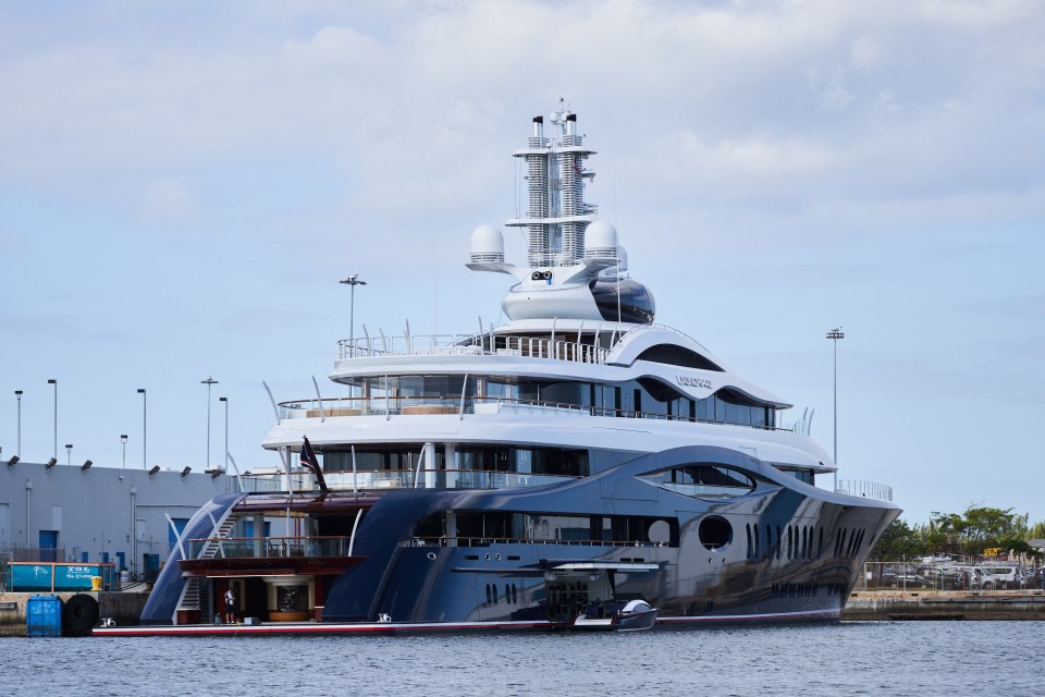 a very large yacht is docked in a harbor