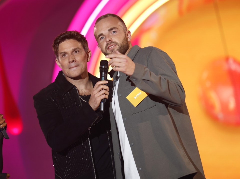 a man with a name tag that says ryan stands next to another man