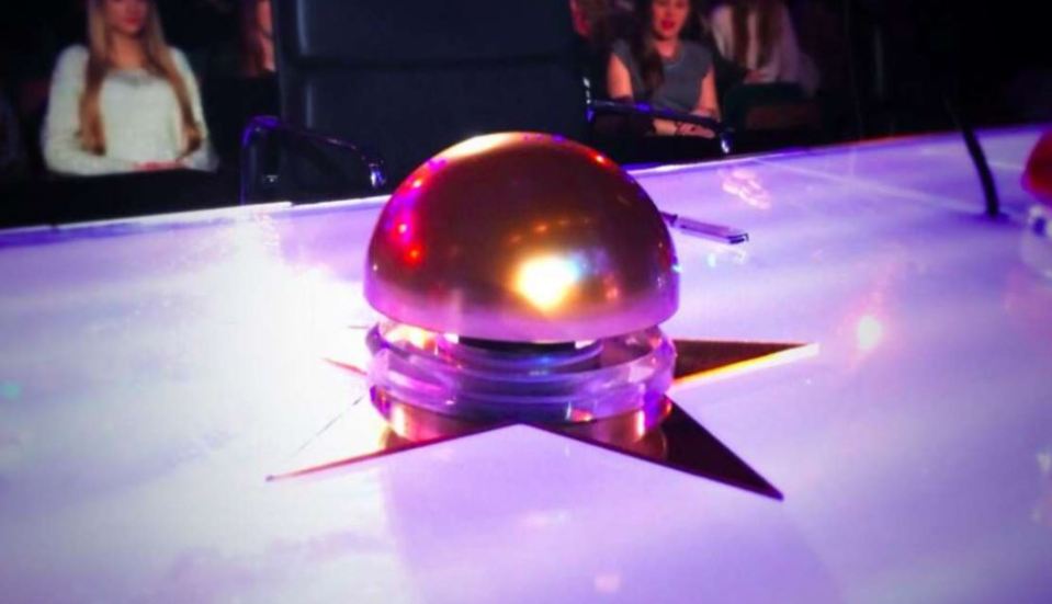 a gold button with a star on it sits on a table