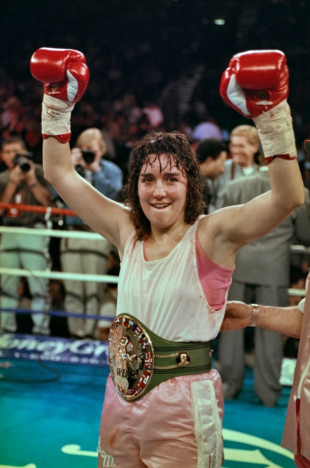 a woman wearing boxing gloves and a belt that says wbc on it