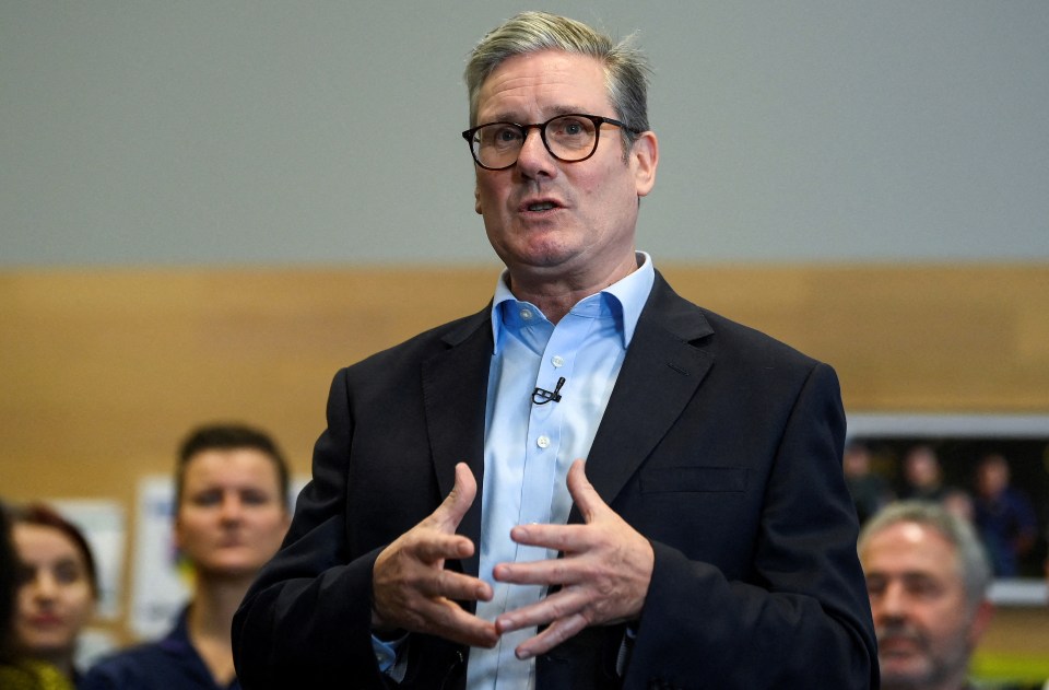 a man with glasses and a poppy on his shirt