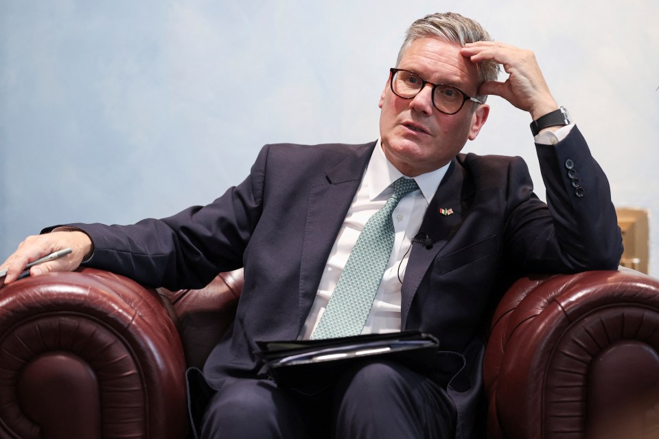 a man in a suit and tie is sitting in a chair