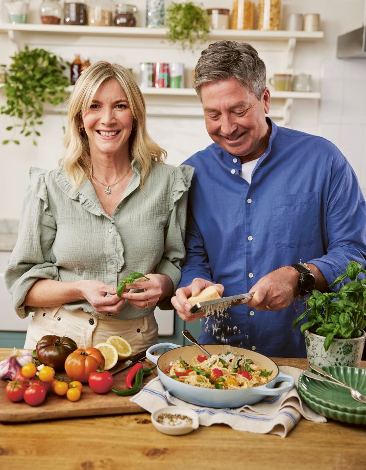 a man and a woman are preparing food in a kitchen