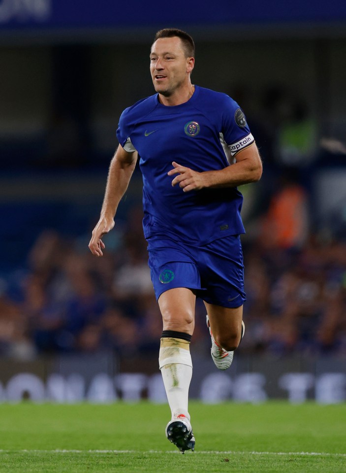 a man in a blue shirt with the word captain on his arm