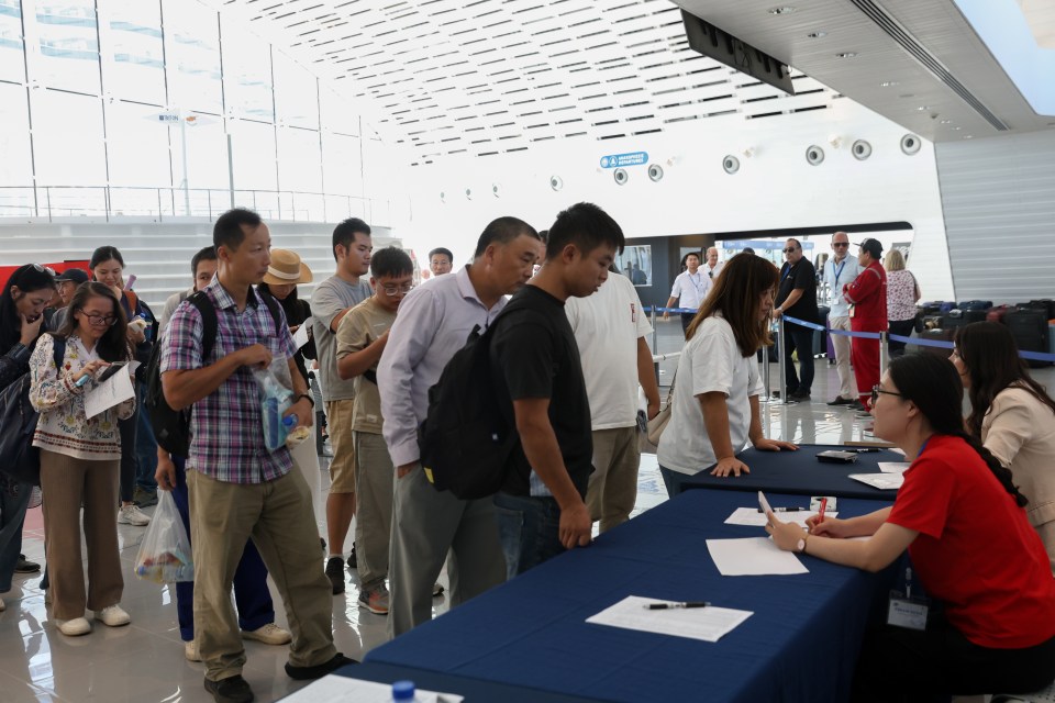 a group of people standing around a table with a sign that says exit