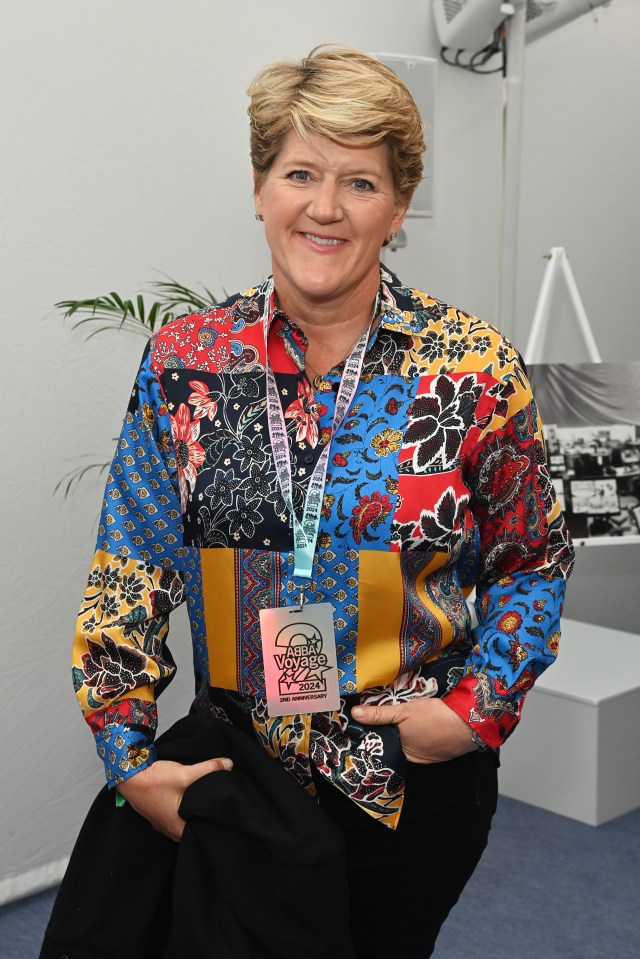 a woman wearing a colorful shirt and a lanyard that says ' women 's world cup ' on it