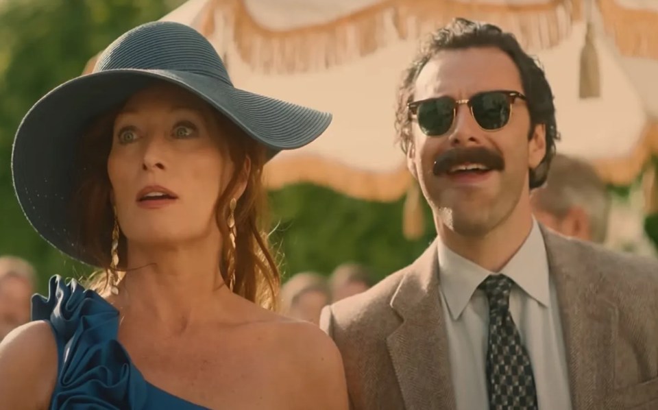 a man and a woman are standing next to each other and the woman says oh my god it 's him