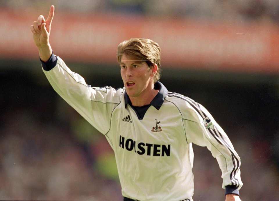 a soccer player wearing a white holsten jersey