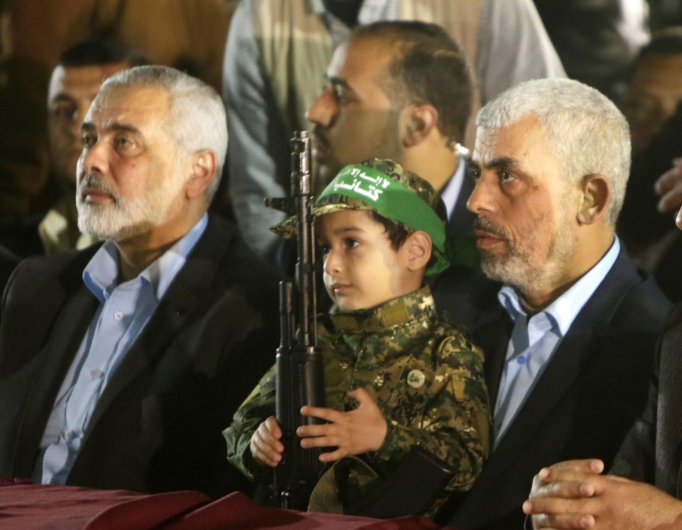 a little boy wearing a green hat that says ' freedom ' on it
