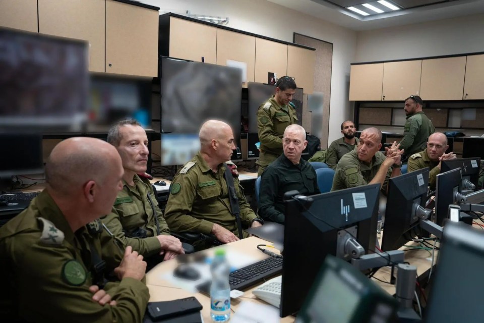 a group of soldiers sit in front of a hp computer