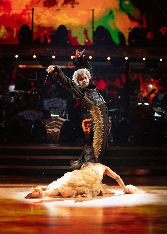 a man and a woman are dancing on a dance floor