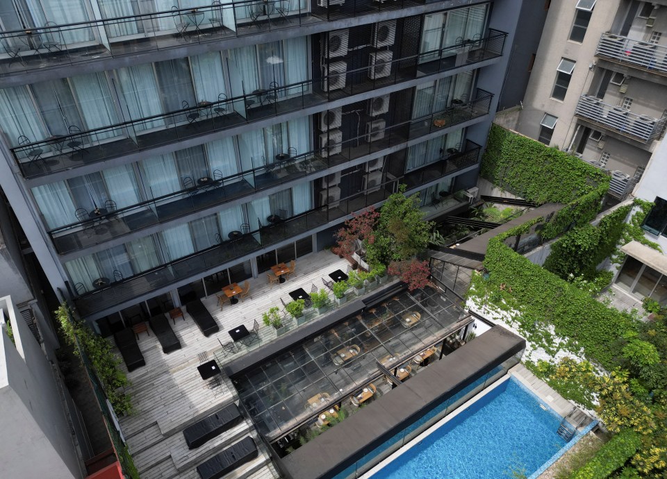 an aerial view of a hotel with a swimming pool
