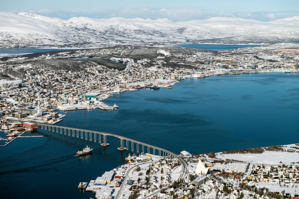 an aerial view of a large body of water with mountains in the background