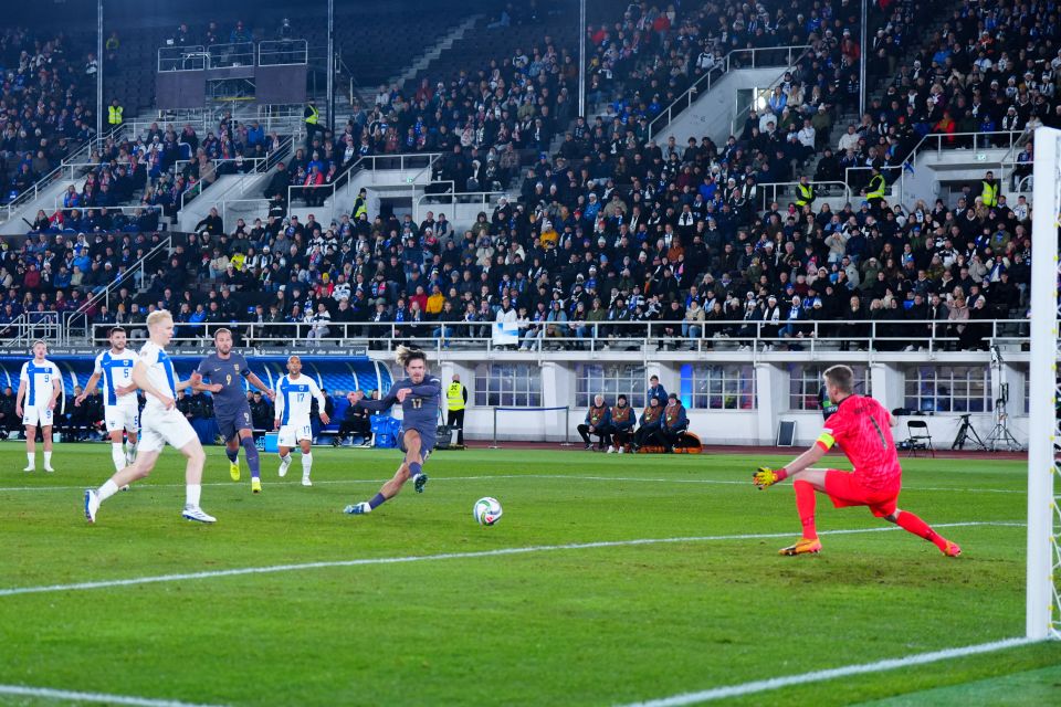 a soccer player kicking a ball in front of a sign that says gear up in the box
