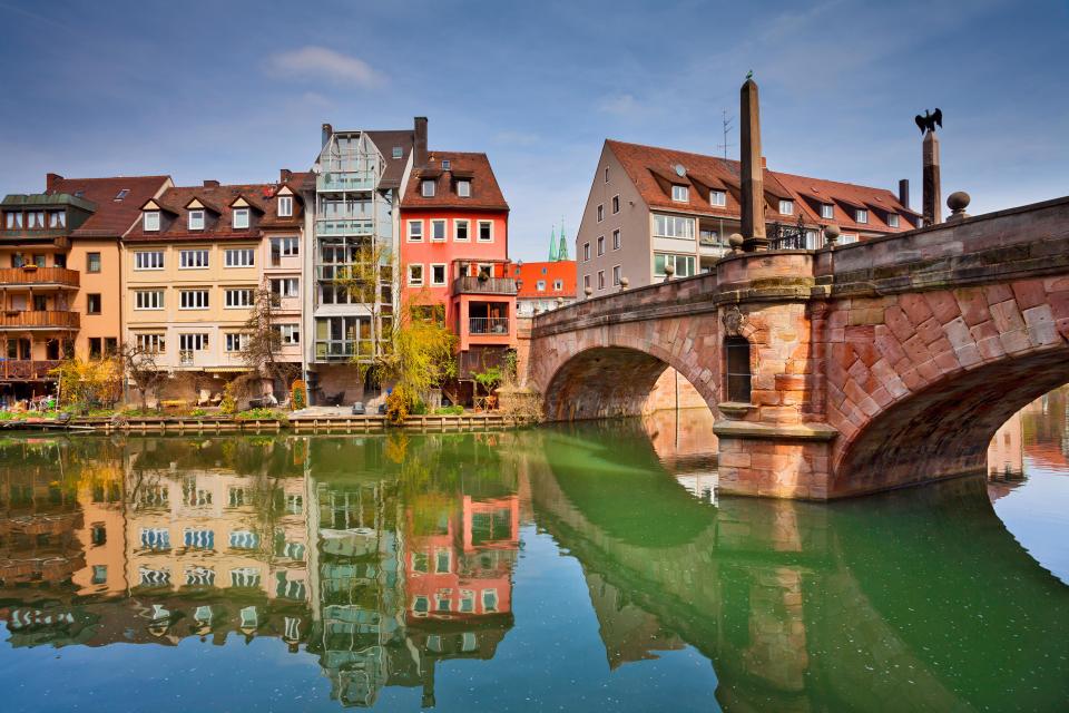 a bridge over a body of water with buildings in the background