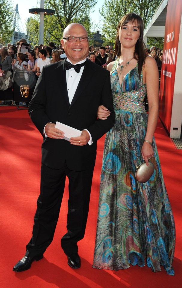 a man and woman on a red carpet in front of a sign that says glamour
