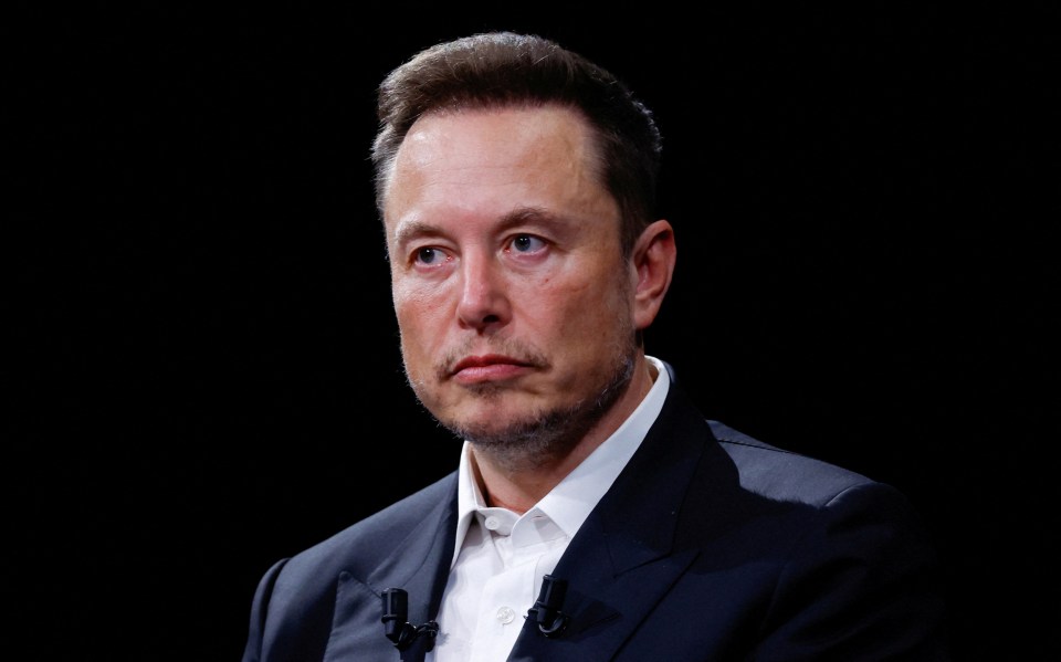 a man with a beard wearing a suit and white shirt