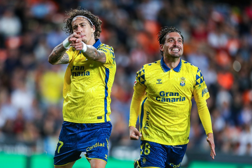 two soccer players wearing yellow jerseys that say gran canaria
