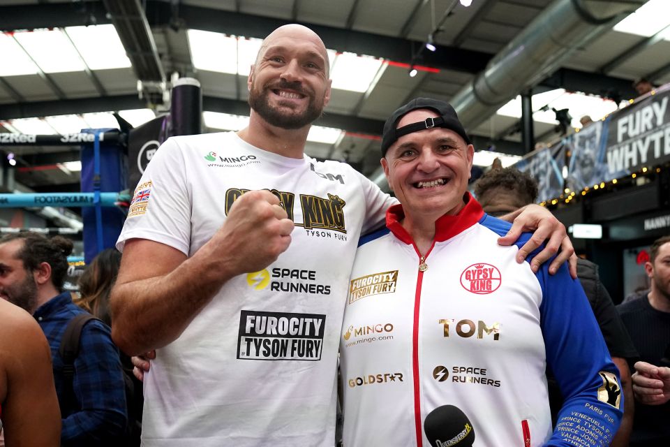 two men posing for a picture with one wearing a shirt that says furocity tyson fury