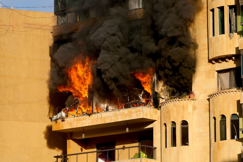 Flames rise from an apartment which caught fire after an Israeli airstrike in Beirut