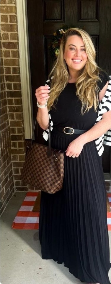 a woman in a black dress is holding a checkered bag