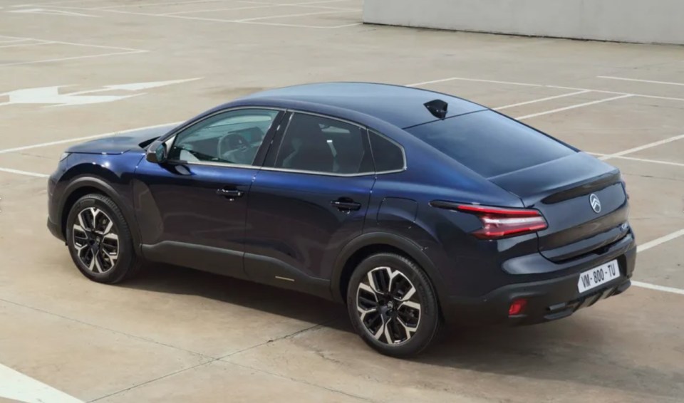 a blue car is parked in a parking lot and has a license plate that says hw-860-tu