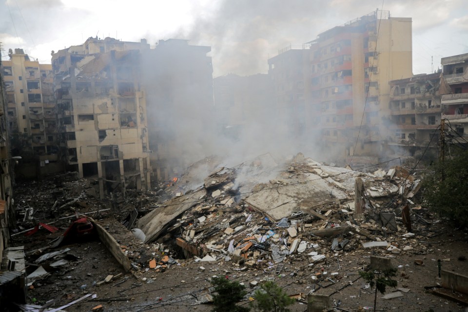 a pile of rubble with smoke coming out of it